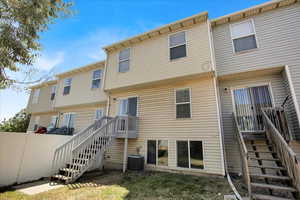 Rear view of house featuring stairs and a residential view