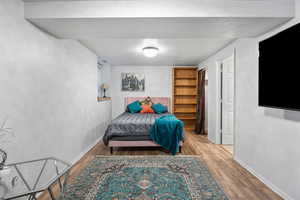 Bedroom featuring a textured ceiling and wood finished floors