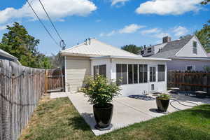 Back of house with a gate, a fenced backyard, and a patio area