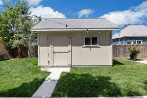 View of shed with a fenced backyard