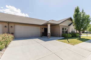 Ranch-style house with concrete driveway, a garage, and a shingled roof