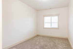 Spare room with carpet floors and baseboards