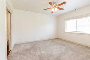 Unfurnished bedroom featuring carpet floors and ceiling fan