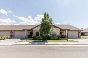 Ranch-style home featuring concrete driveway, a garage, and a shingled roof