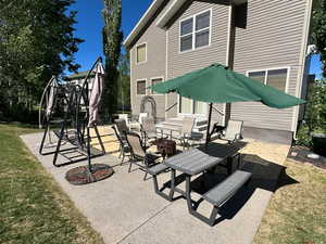 View of patio with an outdoor fire pit