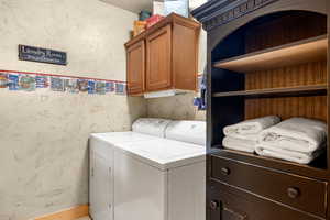 Laundry room with a washing machine and dryer, and cabinet space