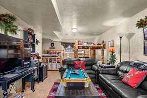 Family room with carpet flooring and a textured ceiling