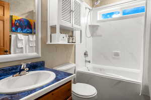 Bathroom with vanity and shower / tub combo with curtain