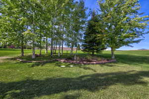 View of grassy yard, bordering a golf course