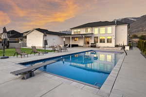 View of swimming pool featuring a patio area and a diving board