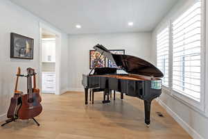 Sitting room with light wood-style flooring and recessed lighting
