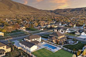Aerial view at dusk of view of pool, a residential view, and a mountain view