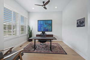 Office space with light wood-style flooring, a ceiling fan, and recessed lighting
