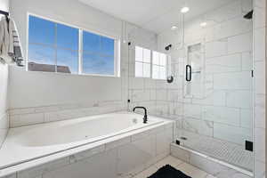 Full bath featuring a bath and a stall shower