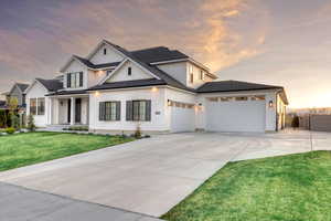 Modern inspired farmhouse with roof with shingles, board and batten siding, driveway, and a garage