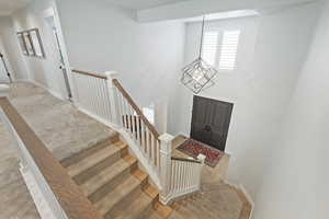 Foyer entrance featuring a chandelier and wood finished floors