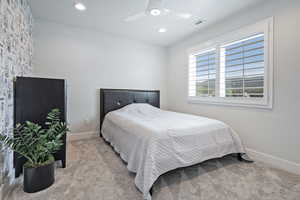 Carpeted bedroom featuring a textured ceiling, recessed lighting, and ceiling fan