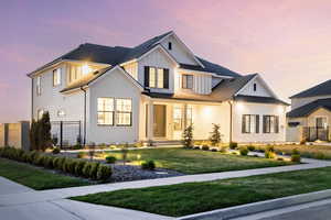 Modern farmhouse style home with board and batten siding, brick siding, and a shingled roof