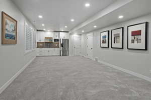 Unfurnished living room with recessed lighting and light carpet