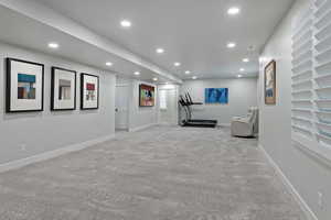 Workout area featuring recessed lighting and light colored carpet