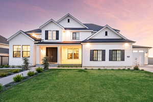 Modern inspired farmhouse with board and batten siding, a front yard, covered porch, concrete driveway, and a garage