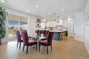Dining area with recessed lighting and light wood-style flooring