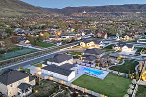 Aerial perspective of suburban area with a pool and a mountain backdrop