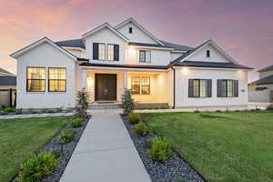 Modern farmhouse featuring board and batten siding and brick siding