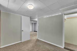 Carpeted empty room with baseboards