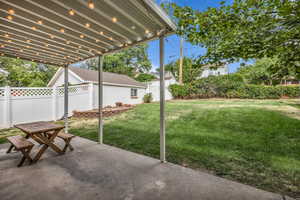 Fenced backyard featuring a patio area and outdoor dining space