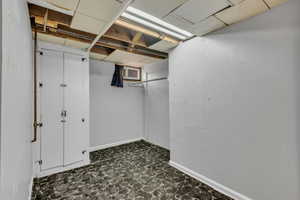 Finished below grade area with baseboards and dark flooring