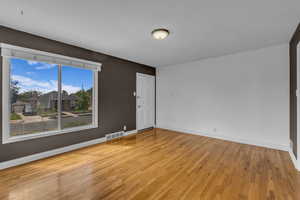 Empty room featuring light wood-type flooring and baseboards