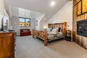 Carpeted bedroom featuring lofted ceiling and recessed lighting