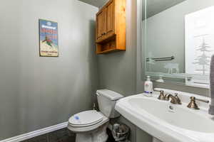 Half bath featuring a sink and toilet