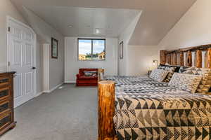 Bedroom with carpet and attic access