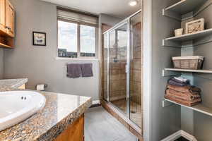 Full bathroom with a shower stall and vanity