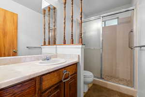Bathroom featuring vanity and a stall shower