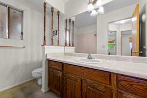 Full bathroom with vanity, a shower, and a chandelier