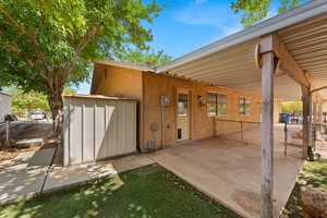 View of patio / terrace with a gate and a shed