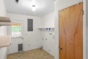 Laundry area featuring hookup for a gas dryer and electric panel