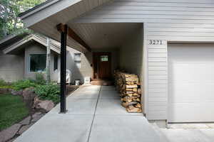 Doorway to property with a garage