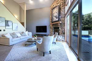 Living room featuring a stone fireplace