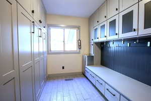 Mudroom with baseboards and light wood-style flooring