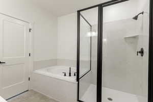 Full bathroom with a garden tub, a marble finish shower, and tile patterned flooring