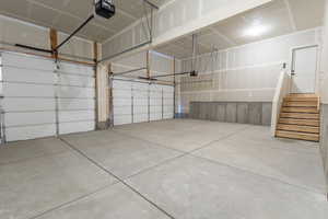 Garage featuring a garage door opener