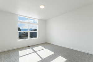 Carpeted spare room with baseboards and a mountain view