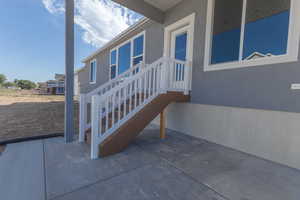 View of side of home featuring a patio and stucco siding