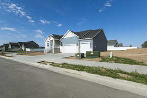 Ranch-style home with concrete driveway, board and batten siding, a residential view, and a garage