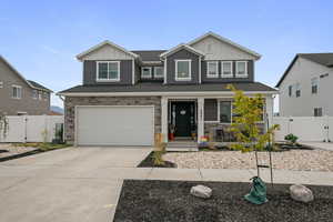 Craftsman house featuring board and batten siding, a gate, a porch, and stone siding
