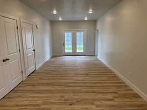 Doorway to outside featuring wood finished floors and baseboards